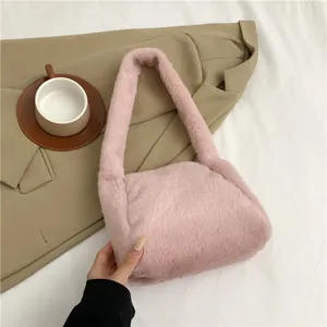 Detailed shot of pink faux fur shoulder bag texture on minimalist fabric background