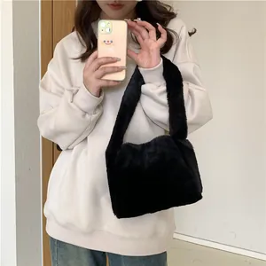 Minimalist black faux fur shoulder bag for women with plush texture and cozy autumn style