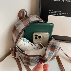 Fashion tweed plaid backpack with leather straps showing interior storage for daily items