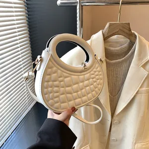 Elegant white bubble texture crescent bag with round handle and adjustable shoulder strap