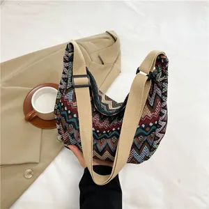 Dettaglio della borsa a tracolla etnica intrecciata con motivi colorati e cinghia regolabile