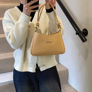 Detail view of yellow hobo shoulder bag with knot strap design and woven texture