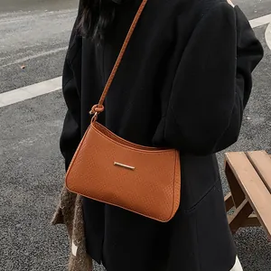 Brown leather crossbody bag with woven texture and gold metal clasp for women