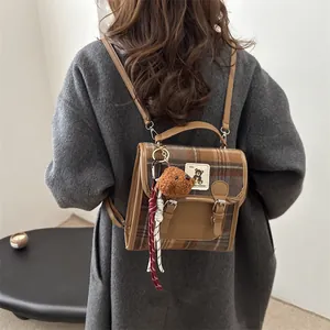Vintage brown plaid backpack with a cute bear charm for students in academic style