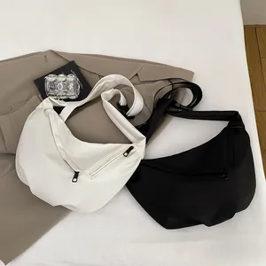 Minimalist canvas crescent crossbody bag in black and white with wide shoulder strap