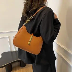 Minimalist caramel brown leather hobo shoulder bag with stylish gold chain strap detail