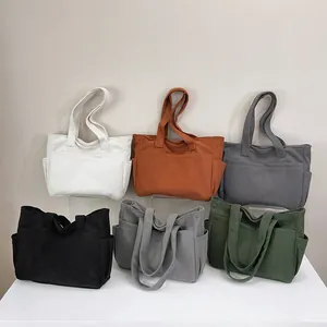 Large corduroy tote bag collection featuring six colors with dual front pockets and long handles