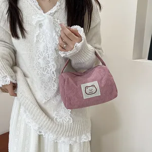 Pink corduroy vanity bag featuring a cute bear patch detail and soft ribbed texture