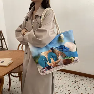 Gros plan détaillé du sac cabas en toile avec imprimés de plage et anses en corde de coton