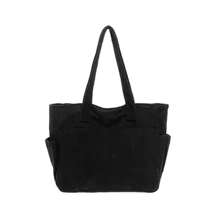 Large black corduroy tote bag with side pockets in a minimalist Japanese style