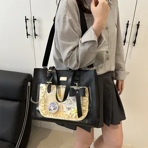 Detail of black ita bag with lace bow decoration and transparent display window for pins