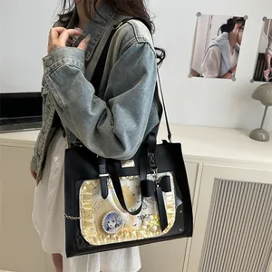 Detailed view of black ita bag with transparent window, lace trim and DIY decorations