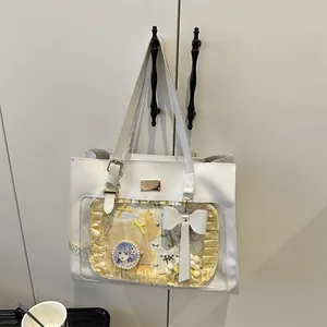 Close-up of a white Ita bag featuring a clear window with lace and bow decoration