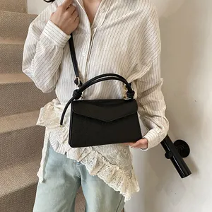Elegant black embossed small square handbag with floral pattern and gold hardware strap