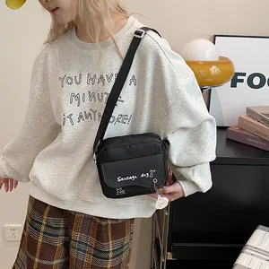 Minimalist black crossbody phone bag with cute sausage dog print and adjustable strap