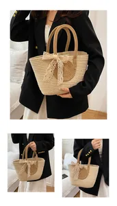 Close-up of woven straw tote bag featuring contrast colors and a delicate lace bow detail