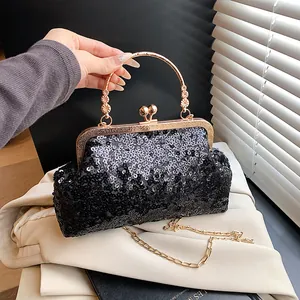 Détail du sac de soirée à paillettes noires avec fermoir baiser doré et poignée fleurie