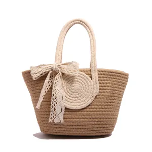 Contrast woven tote bag with a cream lace bow and sturdy round base for summer