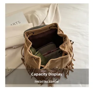 Interior view showing the large capacity of the vintage tassel backpack with personal items
