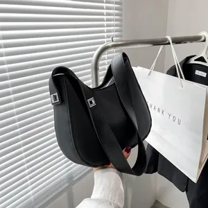 Detail van minimalistische zwarte matte hobo tas met zilveren gesp en brede schouderriem