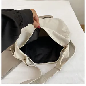 Top view showing large interior capacity and black lining of the cream crossbody tote bag
