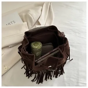 Top view of brown suede backpack interior showing umbrella and wallet storage space