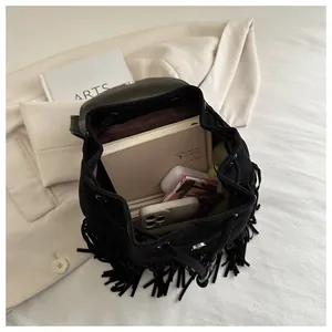 Interior view of black fringe backpack showing capacity for phone and daily essentials