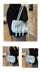 Détail du sac cabas en nylon bleu clair avec des nœuds doux et une texture plissée