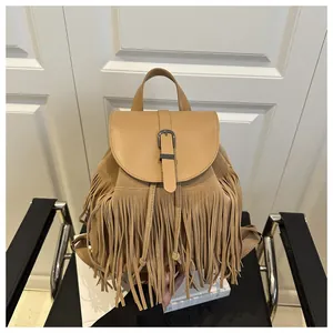 Detail of khaki suede tassel backpack featuring boho fringe and faux leather flap