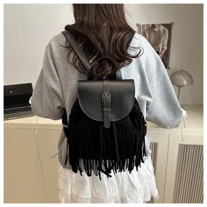 Close-up of black fringe backpack details with smooth leather and matte suede texture