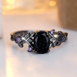 Gothic vine ring with blue goldstone and purple zircons on black gold plated band