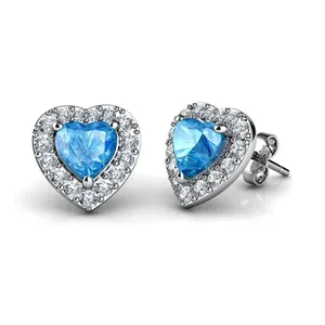 Detail of heart-shaped blue zircon earrings with silver backings and butterfly clasps