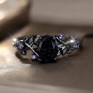 Detailed close-up of a gothic black ring featuring purple gems and vine leaf patterns