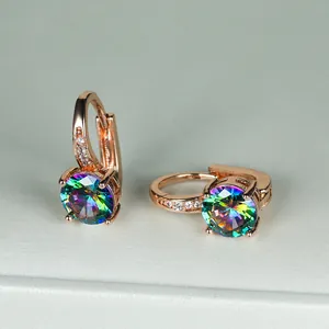 Dettaglio di orecchini tondi con zircone arcobaleno e finitura in oro rosa lucido