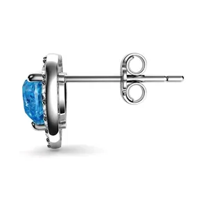 Detailed side view of silver earrings featuring blue gemstone and white zircon accents