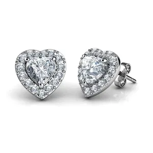 Macro shot of silver heart earrings featuring pink zircon with a diamond-like halo