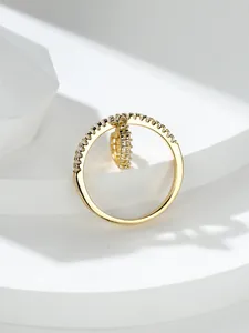 Dettaglio anello con ciondolo a cuore e cristalli pavé su supporto geometrico