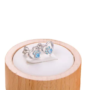 Minimalist heart-shaped stud earrings with blue zircon paw prints in silver metal finish