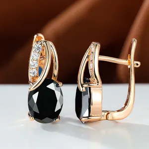 Elegant rose gold earrings with oval black stones and white zircons in a classic setting