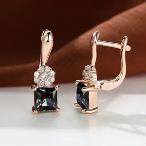 Detailed macro of rose gold lever-back earring with square rainbow crystal and zircon halo