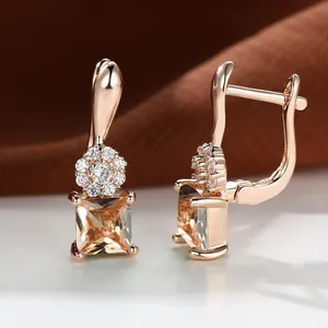 Macro shot of rose gold flower earrings with square champagne zircon and leverback closure