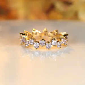 Square-cut blue zirconia eternity ring in gold plating with a creative offset design