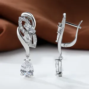Detailed view of silver dangle earrings with pear-cut cubic zirconia and leverback closure
