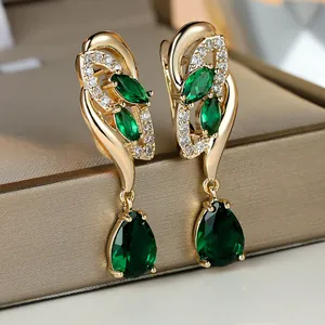 Champagne gold drop earrings with marquise emerald green stones and diamond accents
