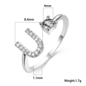Detail view of silver open ring with letter U and cubic zirconia including dimensions