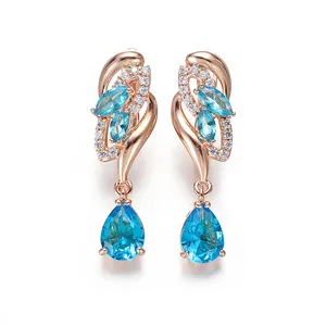 Elegant champagne gold drop earrings with pink diamonds and pear-cut blue gemstones