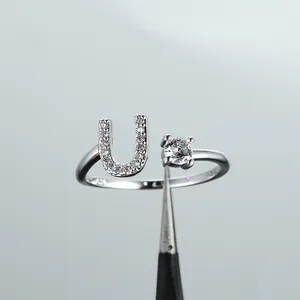 Macro view of S925 stamped silver ring with letter U design and zircon stone