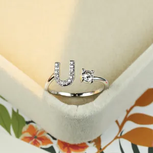 Macro shot of S925 sterling silver open ring with letter U and sparkling zircon stone