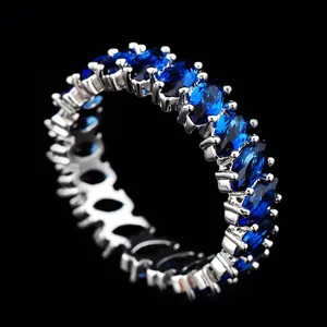 Detail of eternity ring with oval-cut royal blue zircons in a classic claw setting