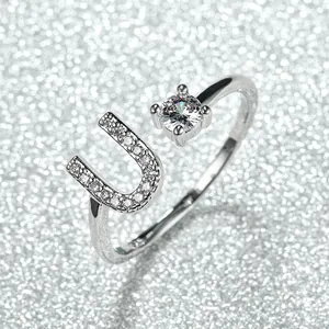 Detail of S925 sterling silver open ring with letter U and sparkling round zircon